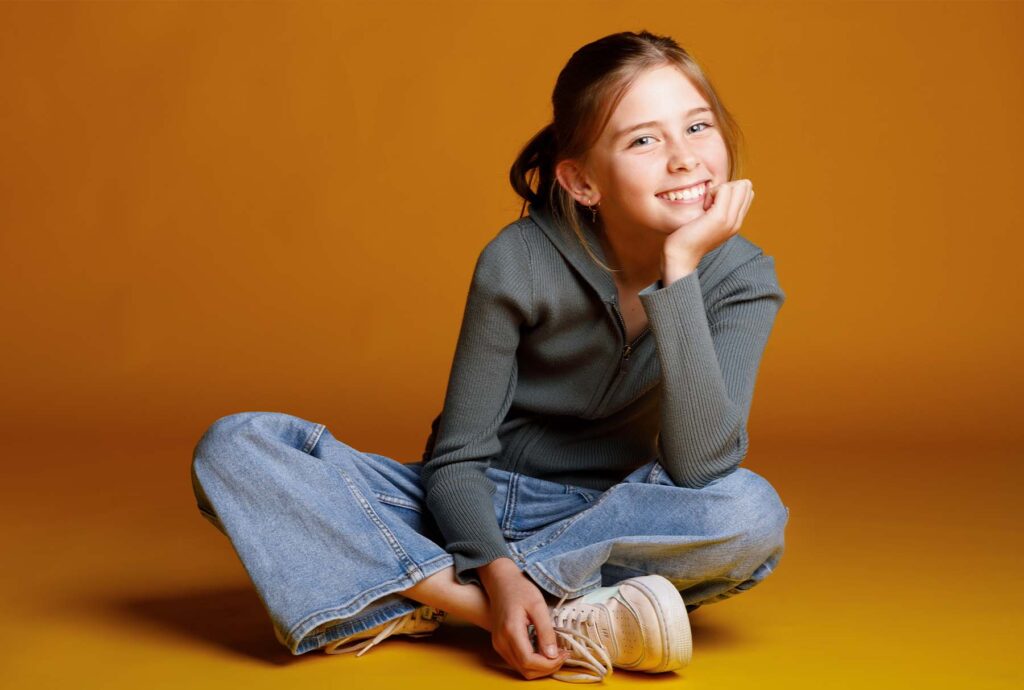 young female teen model in yellow background